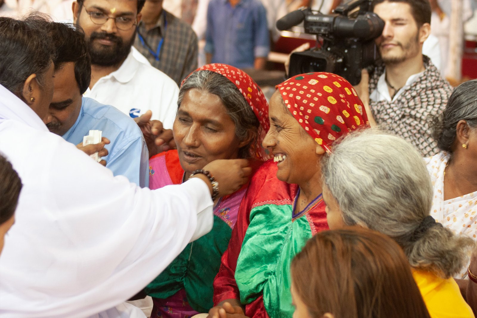 Women from a nearby village attend Amma s 2006 programme in Ahemdabad, Gujarat. Amma has been implementing initiatives for village empowerment for more than 35 years.